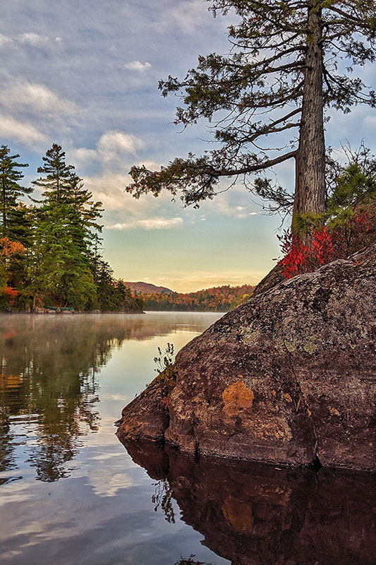 Adirondack Lake with rock and tree on the side.